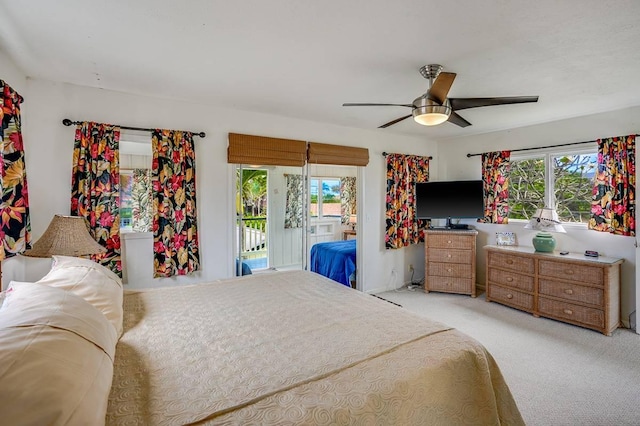 963 Niulani Rd, Kapaa, HI 96746 - bedroom featuring multiple windows, access to outside, light carpet, and ceiling fan