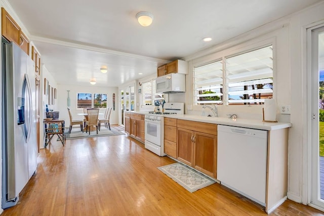 963 Niulani Rd, Kapaa, HI 96746 - kitchen with white appliances, light countertops, light wood-style floors, and brown cabinetry