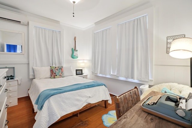 4-950 Kuhio Hwy, Kapaa, HI 96746 - bedroom featuring an AC wall unit, a decorative wall, wood finished floors, and crown molding