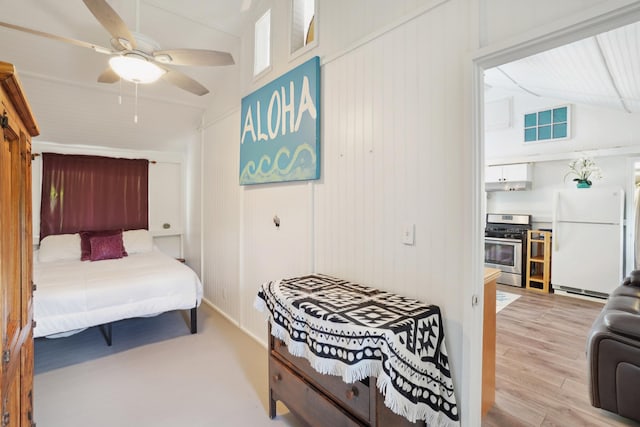 4-950 Kuhio Hwy, Kapaa, HI 96746 - bedroom featuring freestanding refrigerator, vaulted ceiling, light wood-type flooring, and a ceiling fan