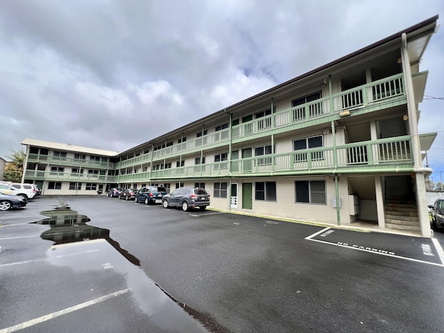 view of building exterior featuring uncovered parking