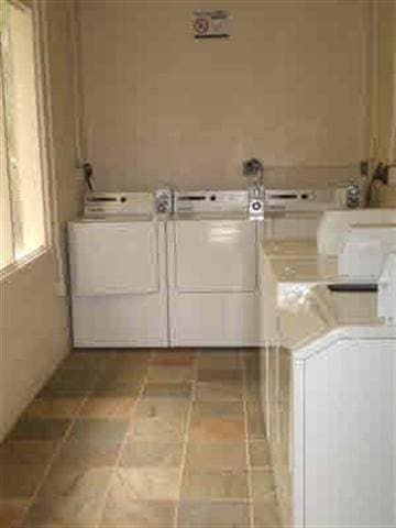 community laundry with washing machine and clothes dryer