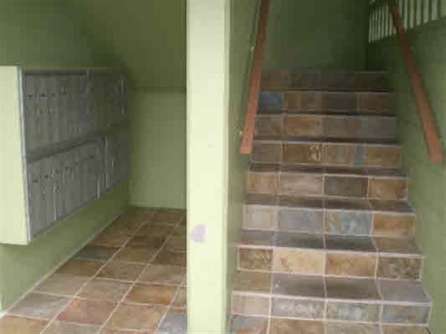 staircase featuring stone finish flooring