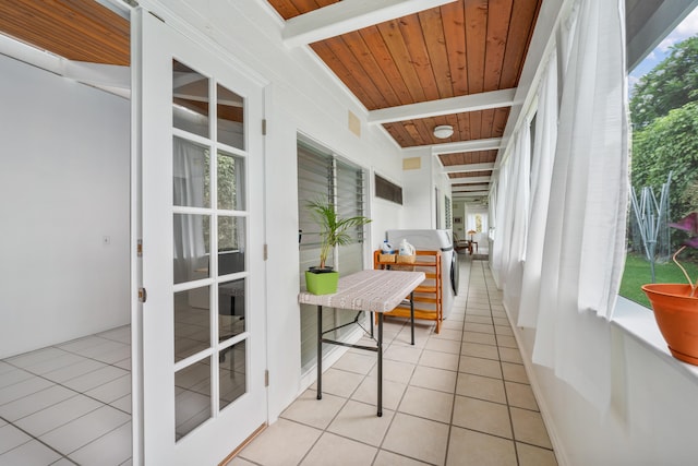 sunroom / solarium featuring beamed ceiling