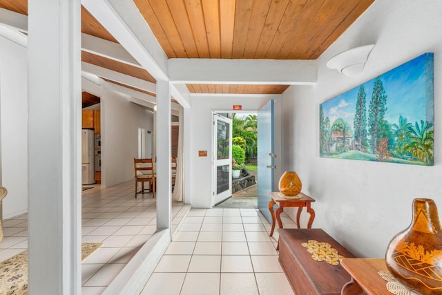 entryway featuring beamed ceiling, light tile patterned floors, and wood ceiling