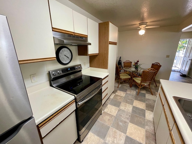 68-3883 Lua Kula St Unit 2005, Waikoloa, HI 96738 - kitchen featuring stainless steel appliances, under cabinet range hood, light countertops, a ceiling fan, and white cabinets