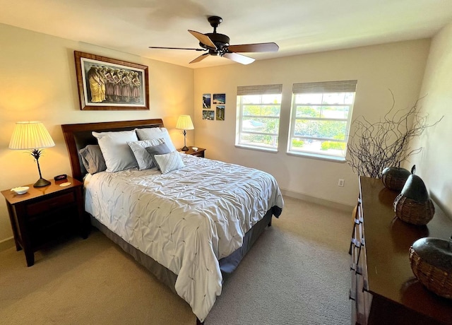 69-1033 Nawahine Pl Unit 10F, Waikoloa, HI 96738 - bedroom featuring light carpet, baseboards, and ceiling fan