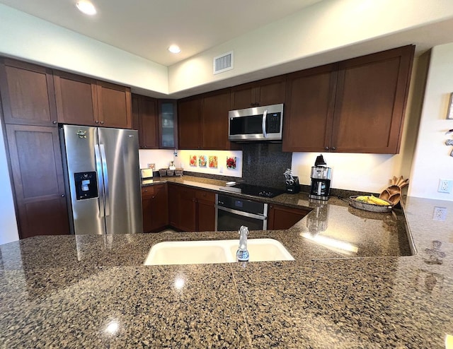 69-1033 Nawahine Pl Unit 10F, Waikoloa, HI 96738 - kitchen featuring stainless steel appliances, a sink, glass insert cabinets, dark stone counters, and recessed lighting