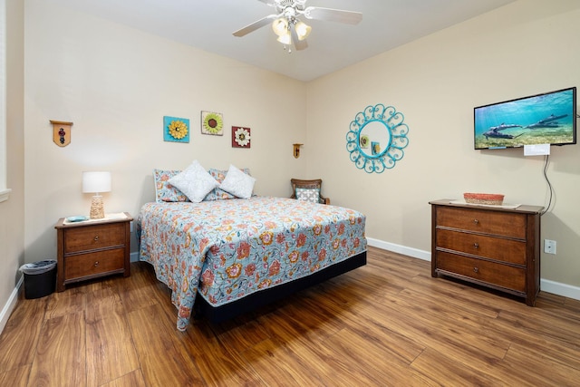 69-180 Waikoloa Beach Dr Unit O2, Waikoloa, HI 96738 - bedroom with baseboards, wood finished floors, and ceiling fan