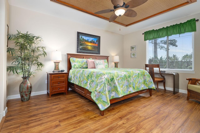 69-180 Waikoloa Beach Dr Unit O2, Waikoloa, HI 96738 - bedroom with a tray ceiling, light wood-style flooring, and baseboards