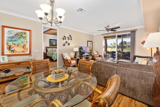 69-180 Waikoloa Beach Dr Unit O2, Waikoloa, HI 96738 - dining room with ornamental molding, wood finished floors, a chandelier, and a ceiling fan