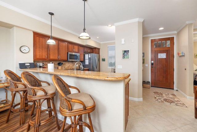 69-180 Waikoloa Beach Dr Unit O2, Waikoloa, HI 96738 - kitchen with stainless steel appliances, a peninsula, light stone counters, recessed lighting, and brown cabinetry