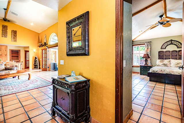 corridor featuring tile patterned floors and a textured wall