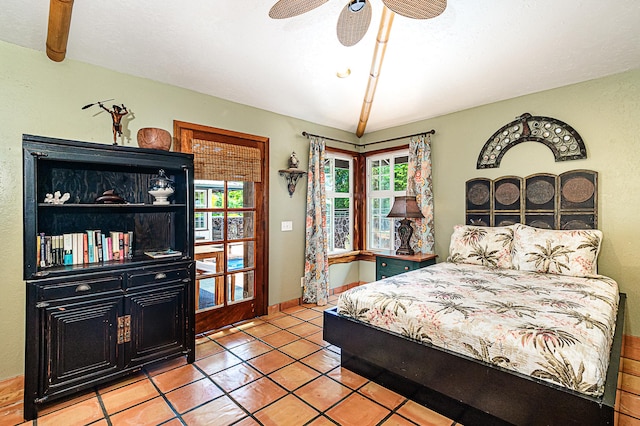 tiled bedroom with multiple windows and ceiling fan