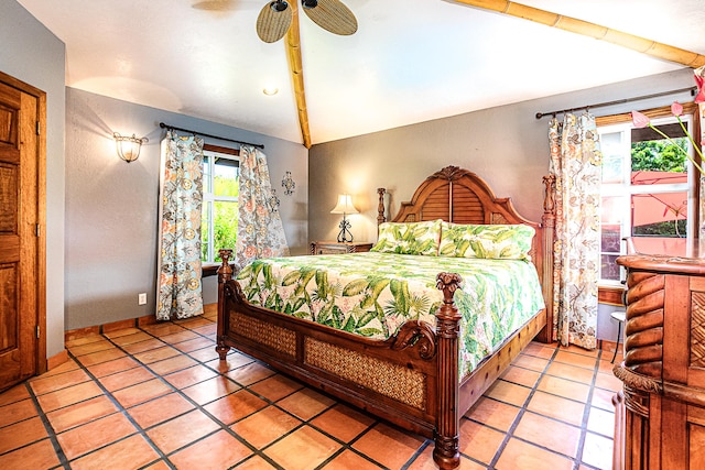 bedroom with vaulted ceiling, light tile patterned floors, ceiling fan, and baseboards