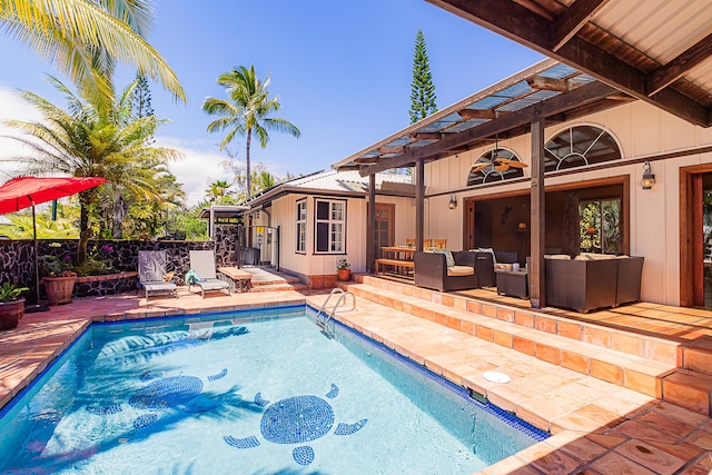 outdoor pool featuring a patio area, outdoor lounge area, and fence
