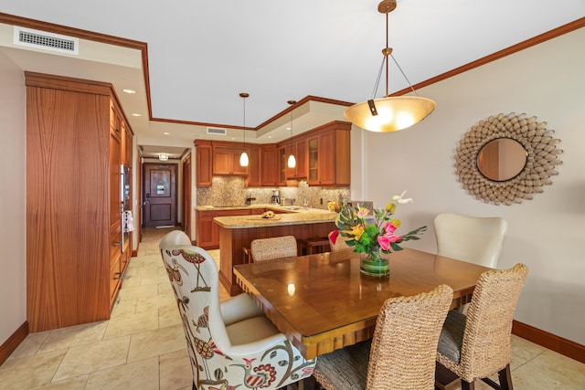 dining room with baseboards and ornamental molding