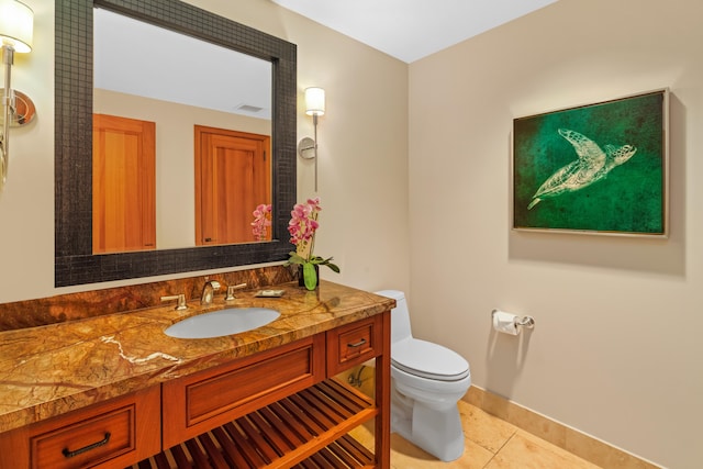 bathroom featuring tile patterned floors, toilet, vanity, and baseboards