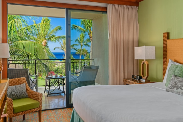 bedroom with a water view and access to outside