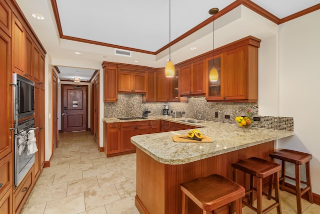 kitchen featuring a peninsula, a sink, decorative backsplash, black appliances, and glass insert cabinets