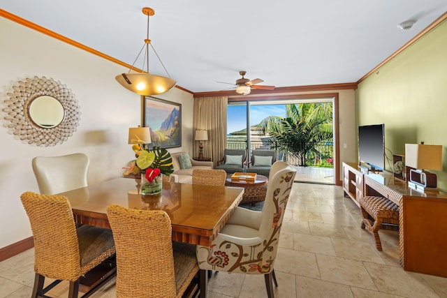 dining room featuring ornamental molding, ceiling fan, and baseboards
