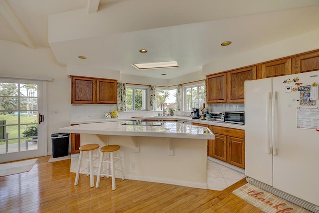 28-3543 Honomu Ln, Honomu, HI 96728 - kitchen featuring freestanding refrigerator, brown cabinets, a kitchen island, light wood-style flooring, and recessed lighting