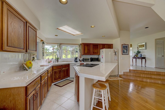 28-3543 Honomu Ln, Honomu, HI 96728 - kitchen with white appliances, a sink, a breakfast bar, a center island, and backsplash