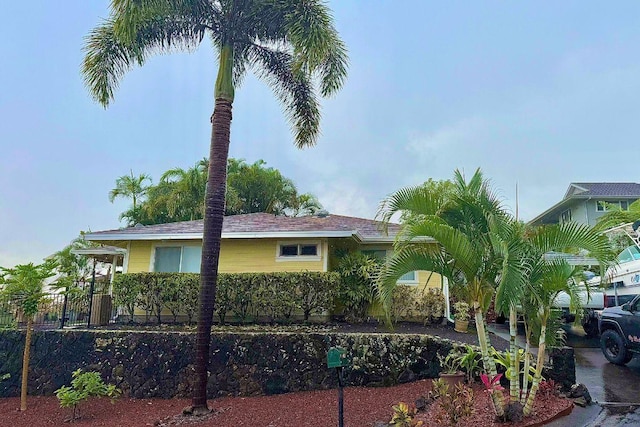 view of side of home featuring fence