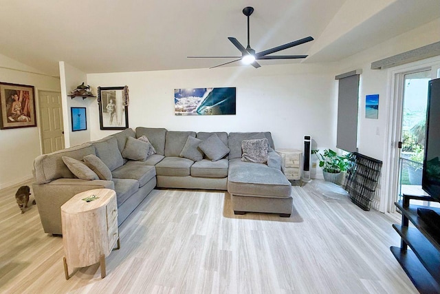 living area featuring vaulted ceiling, ceiling fan, light wood-type flooring, and baseboards