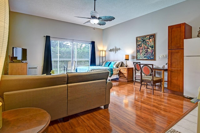 355 Kalanianaole St Unit 119, Hilo, HI 96720 - living area with a ceiling fan, wood finished floors, and a textured ceiling