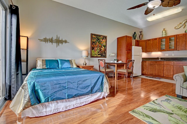 355 Kalanianaole St Unit 119, Hilo, HI 96720 - bedroom featuring freestanding refrigerator, light wood-style flooring, a sink, and lofted ceiling