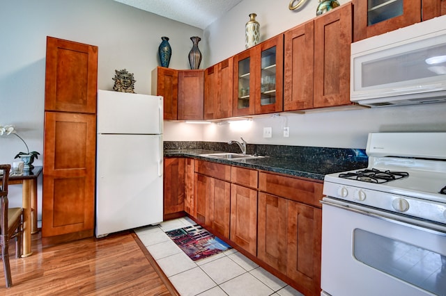 355 Kalanianaole St Unit 119, Hilo, HI 96720 - kitchen with white appliances, a sink, brown cabinets, and a textured ceiling