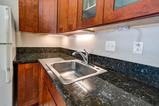 355 Kalanianaole St Unit 119, Hilo, HI 96720 - kitchen with freestanding refrigerator, a sink, brown cabinetry, and glass insert cabinets