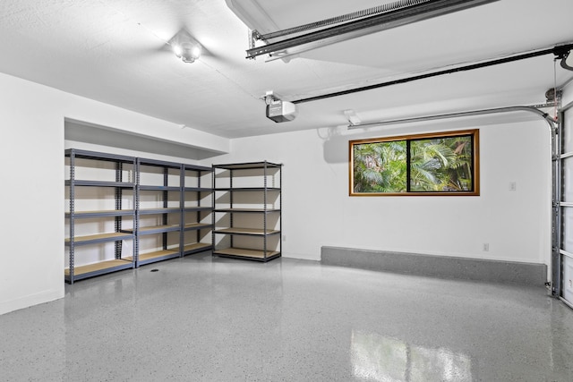 garage with a garage door opener and baseboards