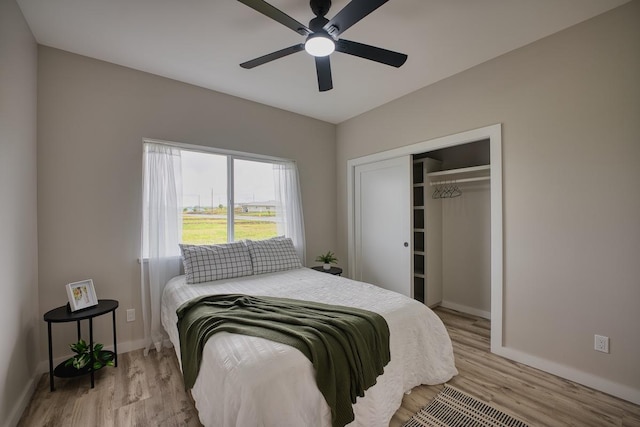 bedroom with baseboards, wood finished floors, a closet, and a ceiling fan