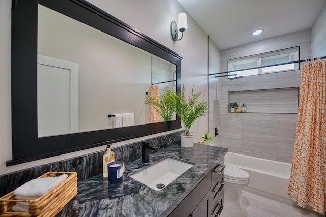bathroom featuring toilet, vanity, and shower / bath combo with shower curtain