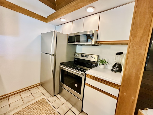 2253 Poipu Rd Unit 446, Koloa, HI 96756 - kitchen with appliances with stainless steel finishes, white cabinetry, light countertops, light tile patterned flooring, and recessed lighting