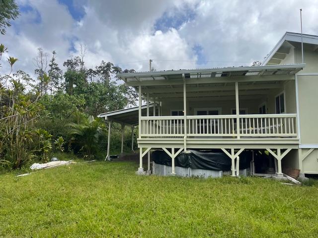 rear view of property with a yard