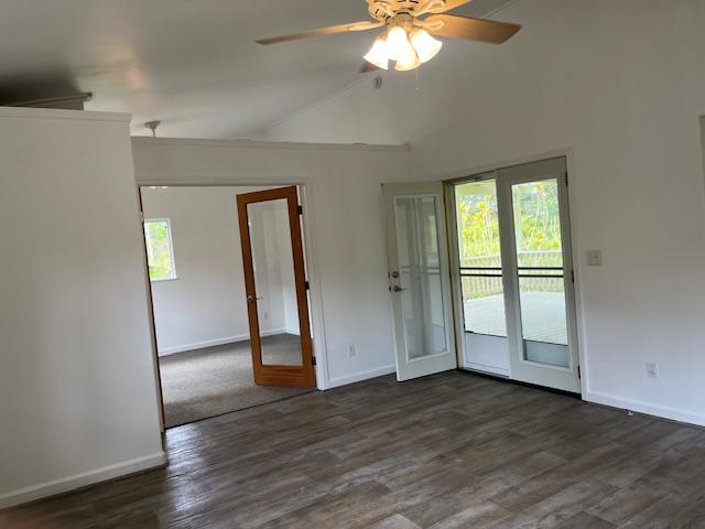 unfurnished room with healthy amount of natural light, baseboards, and lofted ceiling