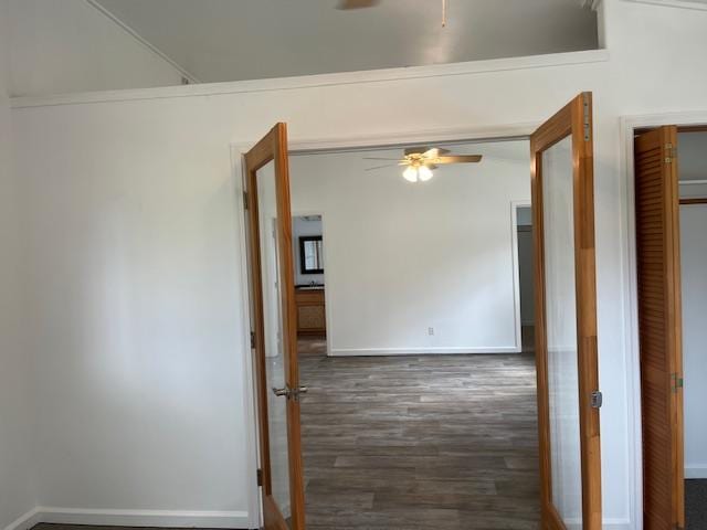spare room featuring a ceiling fan, wood finished floors, and baseboards