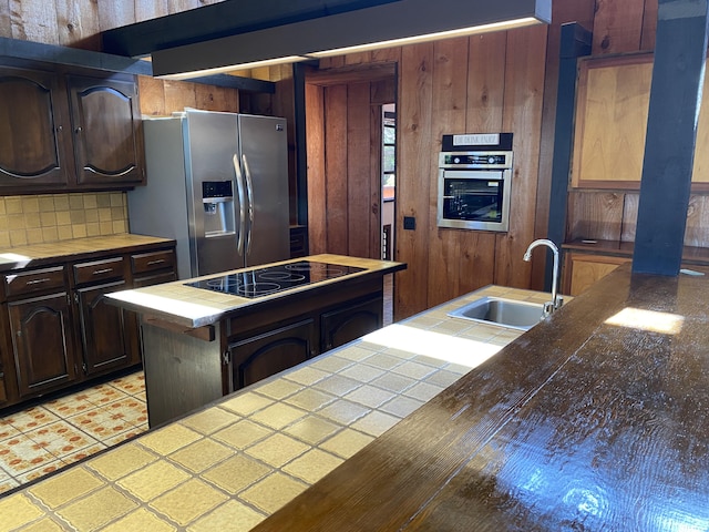 68-1753 Laie Pl, Waikoloa, HI 96738 - kitchen with appliances with stainless steel finishes, a sink, tile countertops, tasteful backsplash, and wooden walls