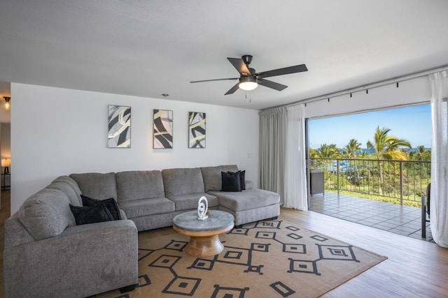 living room with a ceiling fan and wood finished floors