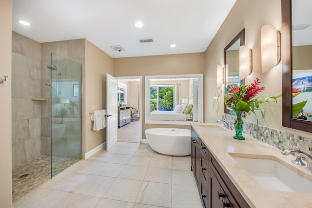 68-1122-N Kaniku Dr Unit 501591, Kamuela, HI 96743 - bathroom featuring a freestanding tub, tiled shower, double vanity, tile patterned flooring, and recessed lighting