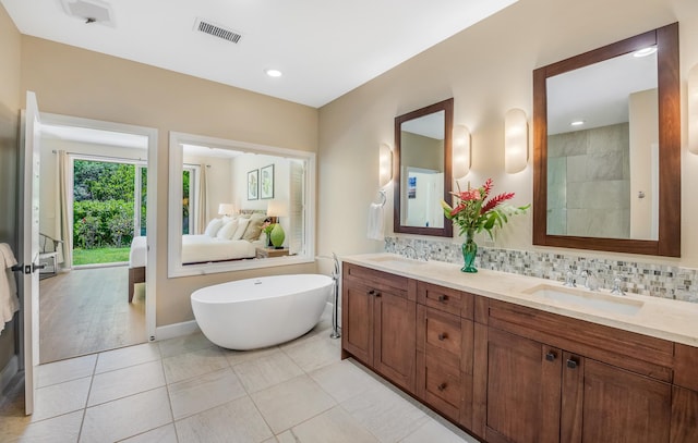 68-1122-N Kaniku Dr Unit 501591, Kamuela, HI 96743 - full bath with double vanity, a soaking tub, backsplash, tile patterned flooring, and recessed lighting