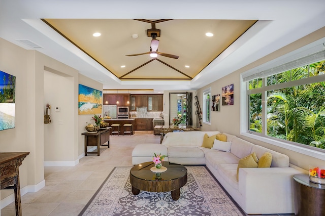 68-1122-N Kaniku Dr Unit 501591, Kamuela, HI 96743 - living area featuring a ceiling fan, vaulted ceiling, a tray ceiling, baseboards, and recessed lighting