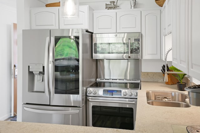 3411 Wilcox Rd Unit B 21, Lihue, HI 96766 - kitchen with appliances with stainless steel finishes, white cabinetry, and light countertops