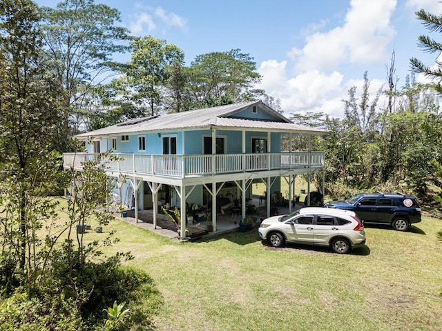 15-1519 14th Ave, Keaau, HI 96749 - rear view of house featuring metal roof, a yard, and a deck