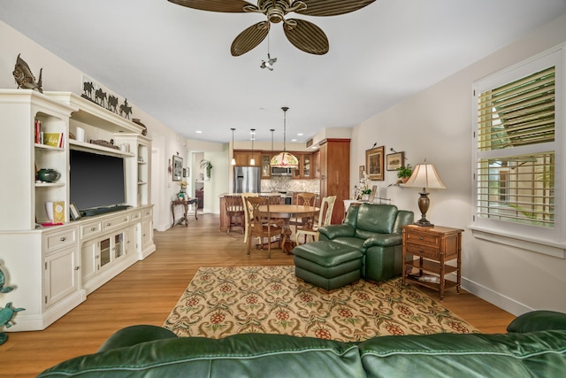 2611 Kiahuna Plantation Dr Unit 13D, Koloa, HI 96756 - living area featuring ceiling fan, light wood-style floors, and baseboards