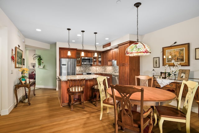 2611 Kiahuna Plantation Dr Unit 13D, Koloa, HI 96756 - dining room with light wood-type flooring, baseboards, and recessed lighting