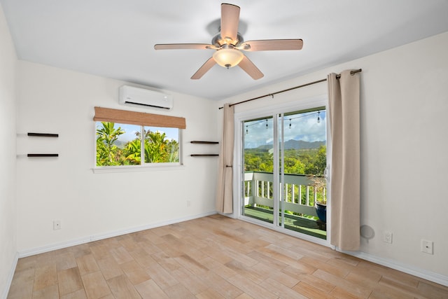 5372 Kumole St, Kapaa, HI 96746 - empty room featuring an AC wall unit, wood finished floors, ceiling fan, and baseboards